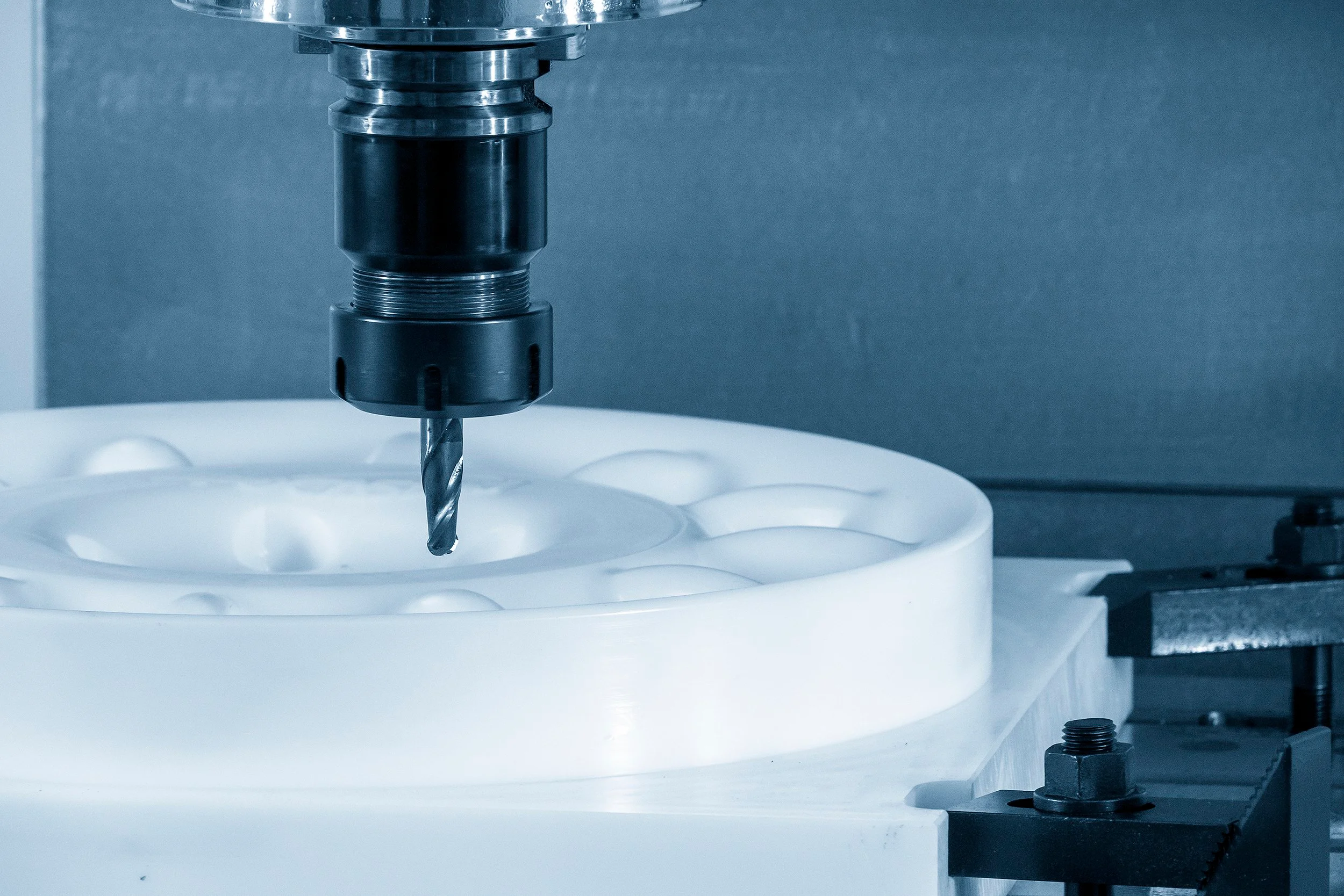 Array of molded plastic components representing the plastics manufacturer’s quality focus
